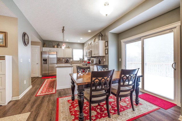 dining room with recessed lighting, dark wood-style flooring, and baseboards