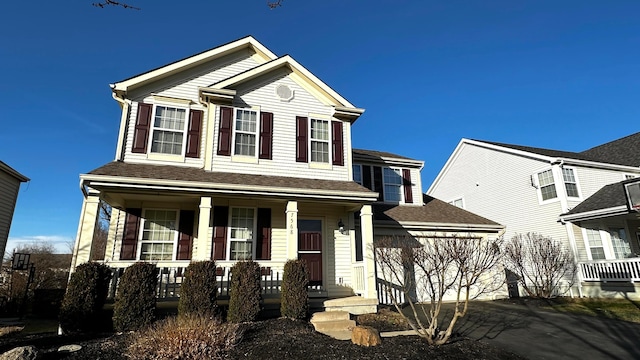 view of front of house with a porch, driveway, and an attached garage