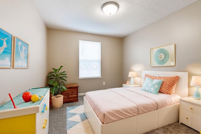 bedroom with a textured ceiling and light colored carpet