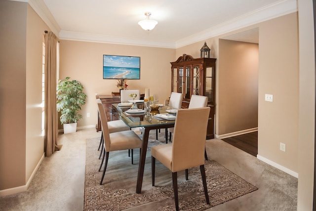 dining room featuring ornamental molding and baseboards