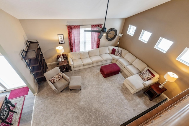 living room featuring a wealth of natural light, vaulted ceiling, stairway, and baseboards