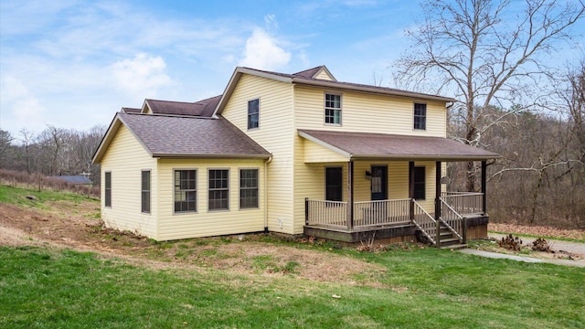 view of front of home with covered porch and a front yard