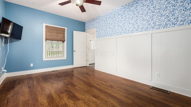 spare room featuring dark hardwood / wood-style floors and ceiling fan