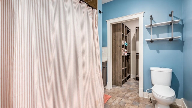 bathroom featuring toilet and walk in shower