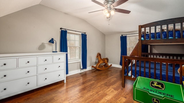 bedroom with lofted ceiling, multiple windows, ceiling fan, and dark hardwood / wood-style floors