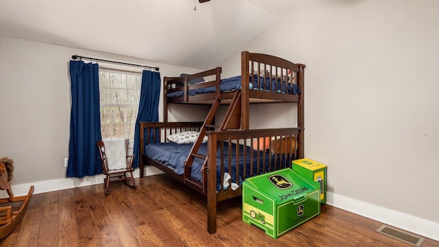 bedroom featuring hardwood / wood-style floors and vaulted ceiling