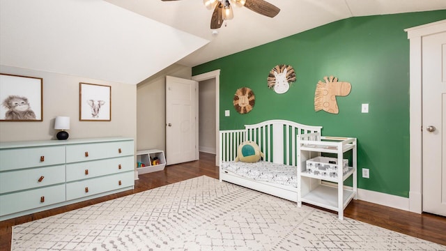 bedroom featuring ceiling fan, dark hardwood / wood-style flooring, and vaulted ceiling