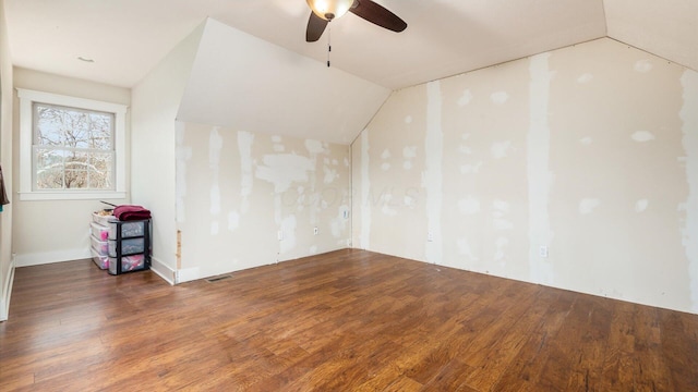 spare room featuring vaulted ceiling, ceiling fan, and dark hardwood / wood-style floors