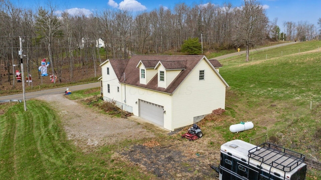 view of side of home with a yard and a garage