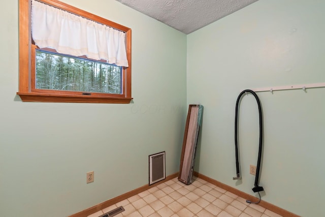 spare room with a textured ceiling