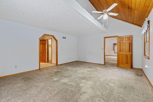 interior space with light carpet, a textured ceiling, vaulted ceiling, and ceiling fan