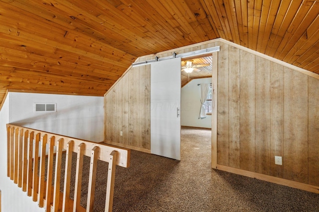 bonus room featuring vaulted ceiling, wooden walls, and wood ceiling