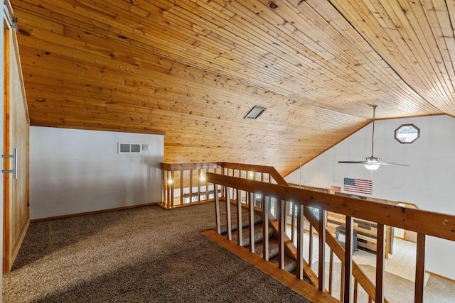 corridor featuring carpet floors, wooden ceiling, and vaulted ceiling