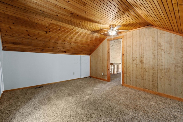 bonus room with carpet, lofted ceiling, wood ceiling, and wooden walls