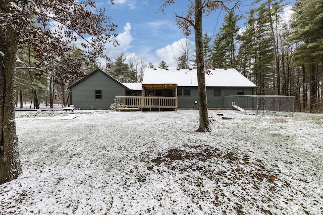 snow covered house with a wooden deck