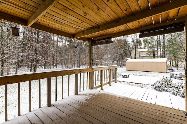 snow covered deck with an outdoor structure