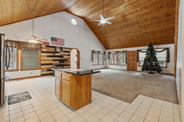 kitchen with light colored carpet, wood ceiling, and high vaulted ceiling