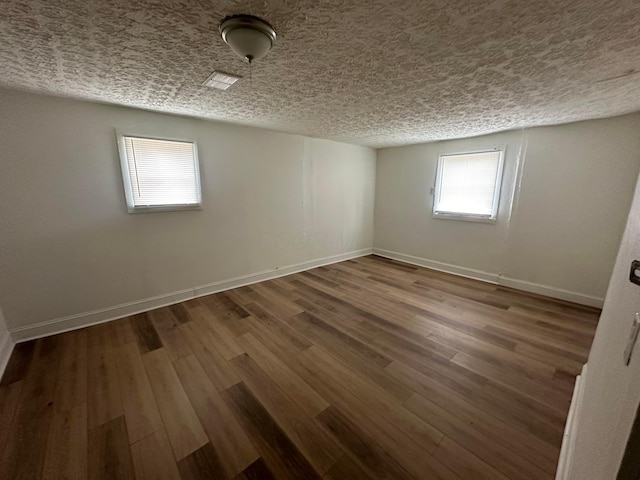 spare room featuring dark wood-type flooring