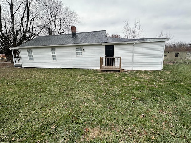 rear view of house with a yard