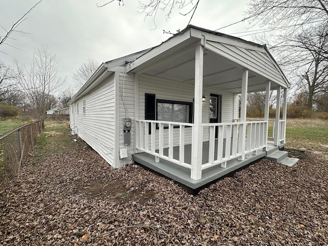 view of side of property with a porch