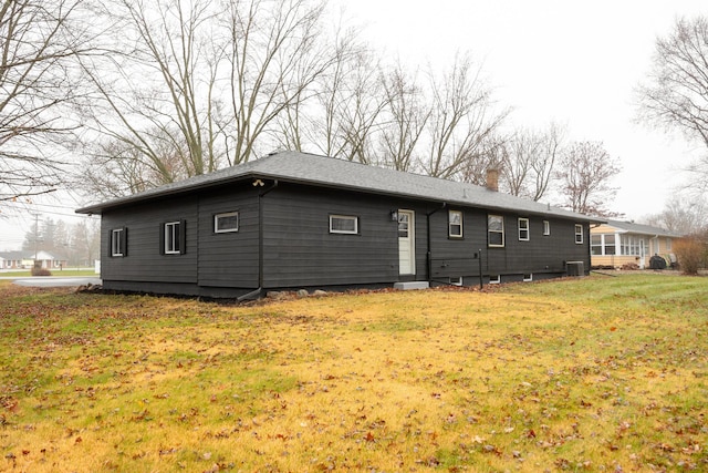 rear view of property with a yard and central AC unit