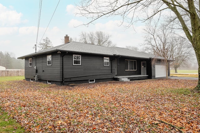 back of property featuring a garage