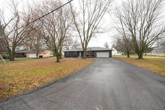 view of front of house featuring a garage and a front lawn