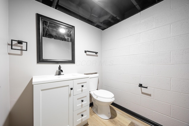 bathroom with vanity, toilet, and wood-type flooring