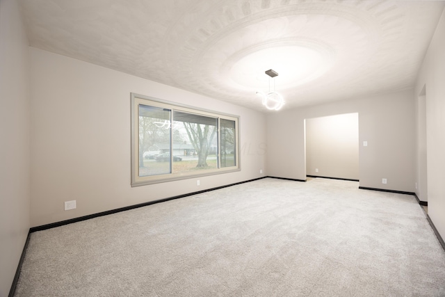 unfurnished room with light carpet