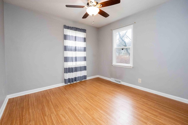 empty room featuring hardwood / wood-style floors and ceiling fan