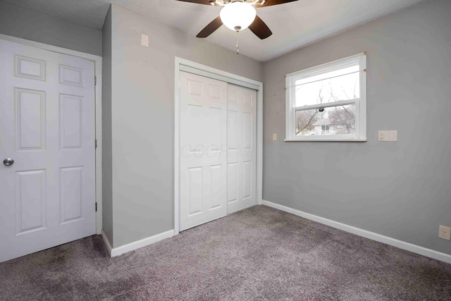 unfurnished bedroom featuring carpet flooring, ceiling fan, and a closet