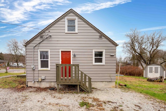 back of property featuring a storage unit