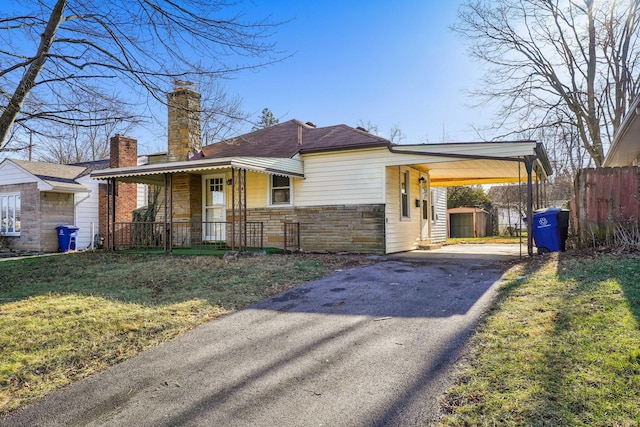 view of front facade with a carport and a front lawn