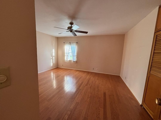 unfurnished room featuring ceiling fan and hardwood / wood-style flooring