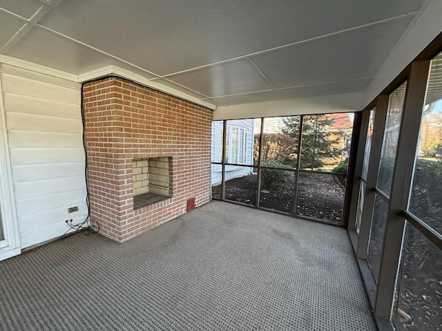 unfurnished sunroom featuring a fireplace