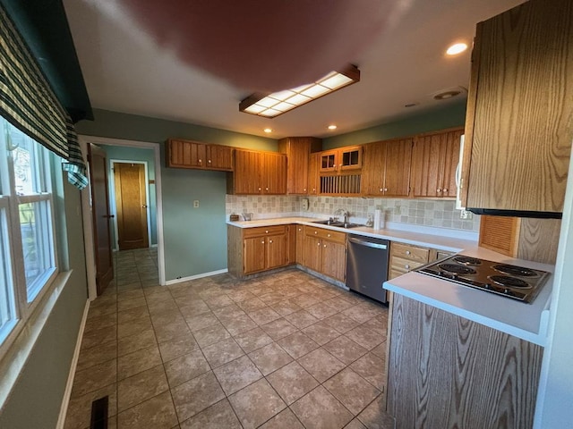 kitchen with backsplash, light tile patterned floors, sink, and appliances with stainless steel finishes