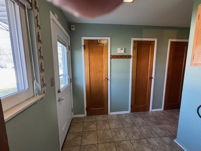 interior space with tile patterned floors and multiple windows