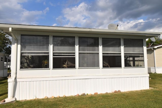 view of side of home with a lawn