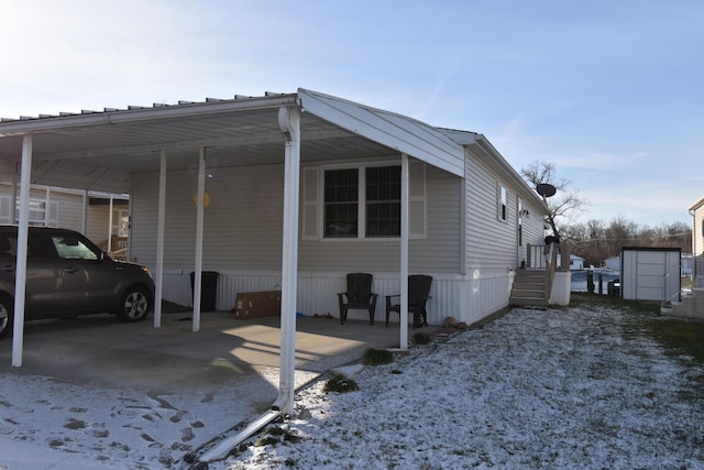 snow covered property with a carport