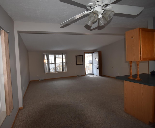 unfurnished living room with ceiling fan and light colored carpet