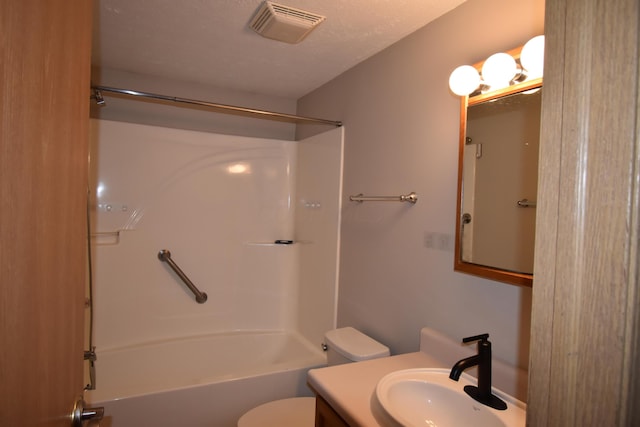 full bathroom with toilet, vanity, shower / bathtub combination, and a textured ceiling