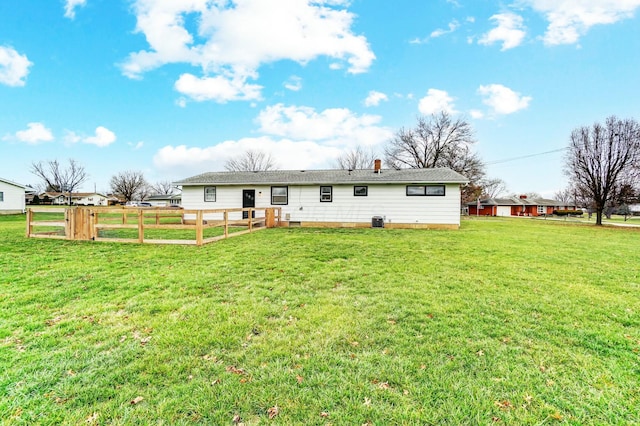 rear view of house with a yard