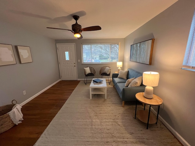 living room featuring ceiling fan and dark hardwood / wood-style flooring