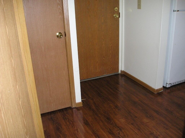 hall with dark hardwood / wood-style floors