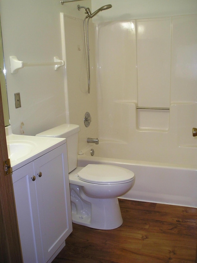 full bathroom featuring wood-type flooring, vanity, shower / bath combination, and toilet