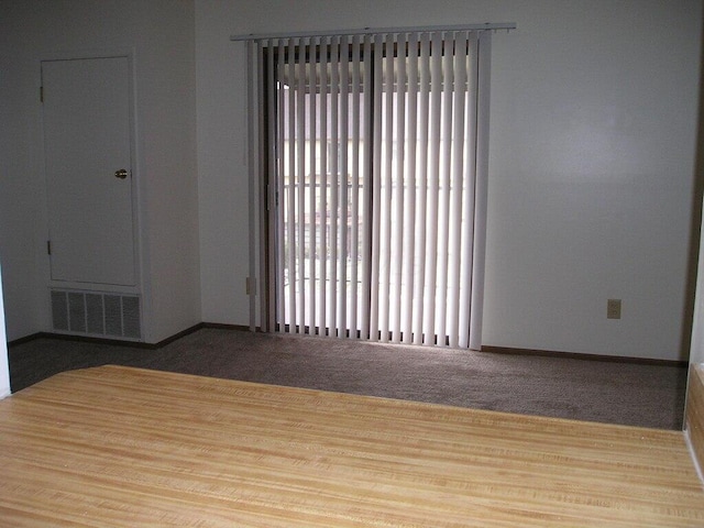 unfurnished room featuring light carpet