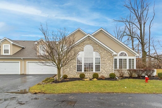 view of front of home with a garage and a front lawn