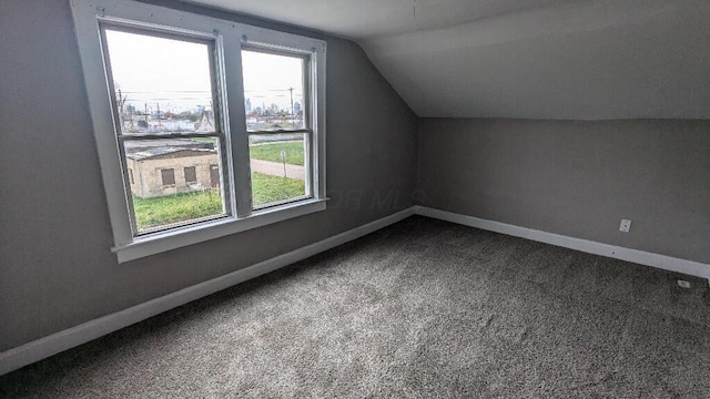 bonus room featuring lofted ceiling and carpet floors