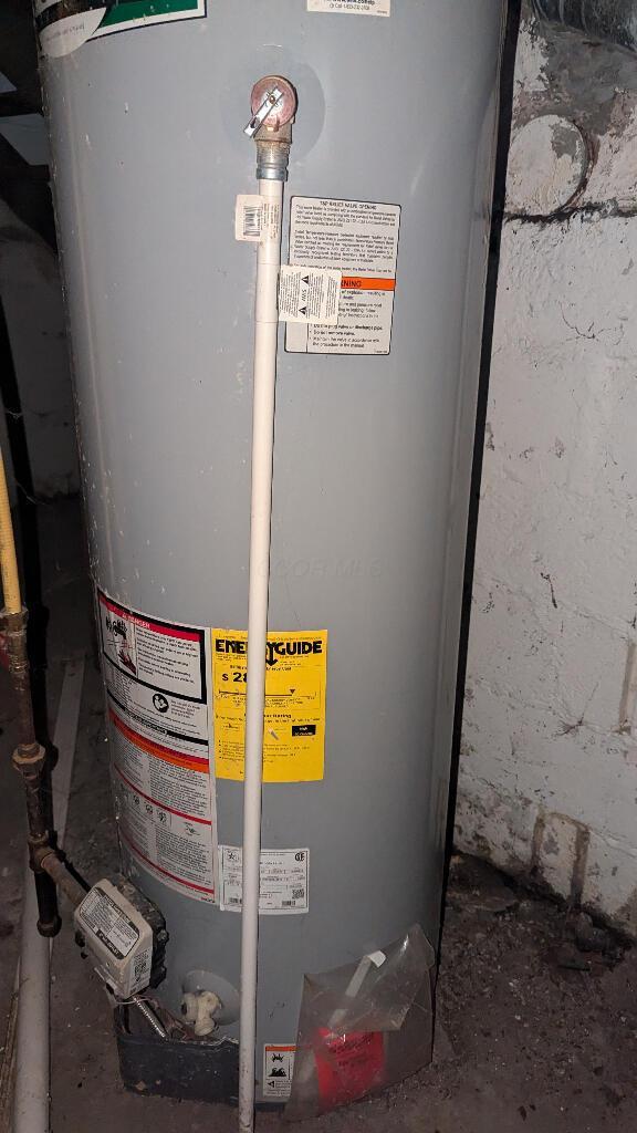 utility room with gas water heater