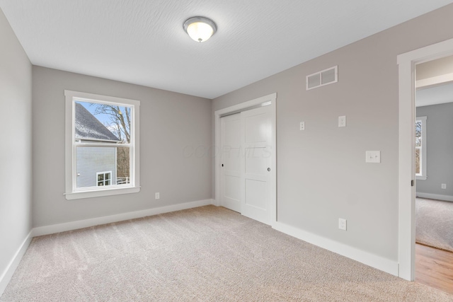 unfurnished bedroom with a closet and carpet floors